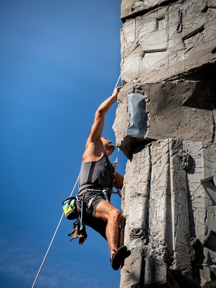 gallery-04 Rock climber with gear scaling artificial wall outdoors in Kaunas, Lithuania.